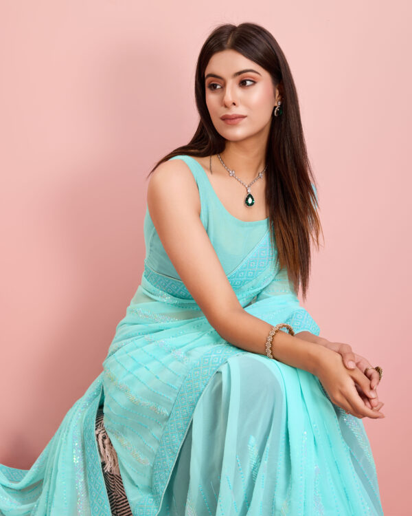 Step into elegance with the Sofisty Women’s Sequences Embroidery Soft Georgette Ready-to-Wear Saree with Lace Border. Designed for the modern woman, this saree combines beauty and convenience. The high-quality soft georgette fabric provides a lightweight, comfortable drape that flows effortlessly, making it perfect for all-day wear during celebrations and parties.